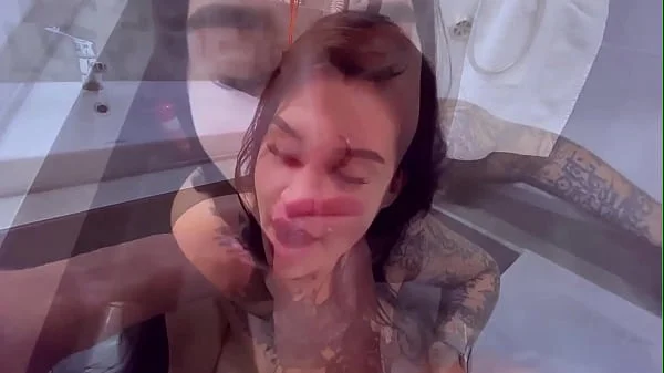 Tattooslutwife sucks a big cock in the bathroom. Gets a load in big mouth