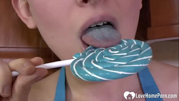 Hot MILF enjoys sucking on a lollipop