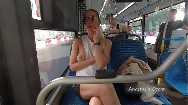 A girl rides a public bus with bare breasts